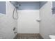 A tiled shower stall featuring a shower head, faucet, and built-in soap dish, ideal for a quick clean at 5126 Shadow Pointe Dr, Indianapolis, IN 46254