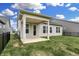 Backyard showcasing an open green lawn, covered patio and black metal fencing at 5309 Spyglass Dr, Whitestown, IN 46075