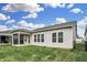Backyard view of an open green lawn, covered patio and black metal fencing at 5309 Spyglass Dr, Whitestown, IN 46075