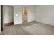 A bright primary bedroom showcasing neutral walls and carpet, with doorways to closet and bathroom at 5309 Spyglass Dr, Whitestown, IN 46075