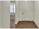 Bright entryway with hardwood floors, white walls, and a view into a carpeted living area at 5309 Spyglass Dr, Whitestown, IN 46075