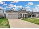 Well-maintained home with a two-car garage, a covered entryway, and coordinated landscaping for curb appeal at 5309 Spyglass Dr, Whitestown, IN 46075