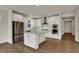 Stunning kitchen featuring a center island, white cabinetry, stainless steel appliances, and hardwood floors at 5309 Spyglass Dr, Whitestown, IN 46075