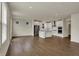 Bright, open-plan living space with wood floors, expansive windows, and a stylish white kitchen at 5309 Spyglass Dr, Whitestown, IN 46075