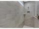 Tiled shower showcasing gray subway tile, a built in shelf and a showerhead at 5309 Spyglass Dr, Whitestown, IN 46075