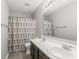 Bathroom with a double sink vanity and a shower with a stylish rectangular pattern shower curtain at 5817 Thompson Park Blvd, Indianapolis, IN 46237