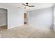 Airy bedroom with neutral carpet, ceiling fan, and an adjoining walk-in closet, perfect for a restful retreat at 5817 Thompson Park Blvd, Indianapolis, IN 46237