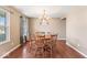 Inviting dining room with beautiful hardwood floors, a stylish chandelier, and ample natural light at 5817 Thompson Park Blvd, Indianapolis, IN 46237