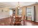 Bright dining room with wood floors, a charming chandelier, and easy access to the front door at 5817 Thompson Park Blvd, Indianapolis, IN 46237