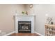 Cozy fireplace with a white mantle and gold trim at 5817 Thompson Park Blvd, Indianapolis, IN 46237