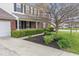 Attractive brick home boasting a lush lawn, tidy landscaping, and an attached garage at 5817 Thompson Park Blvd, Indianapolis, IN 46237