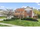 Inviting two-story brick home with green lawn, neat landscaping, and a two-car garage at 5817 Thompson Park Blvd, Indianapolis, IN 46237