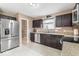 Kitchen with stainless steel appliances, plenty of counter space, and dark brown cabinets at 5817 Thompson Park Blvd, Indianapolis, IN 46237
