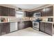 Well-equipped kitchen with stainless steel appliances, and dark wood cabinets at 5817 Thompson Park Blvd, Indianapolis, IN 46237