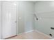 Functional laundry room features tile floors and utility connections for modern appliances at 5817 Thompson Park Blvd, Indianapolis, IN 46237