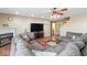 Open living room featuring a fireplace, large television, and comfortable sectional sofa at 5817 Thompson Park Blvd, Indianapolis, IN 46237
