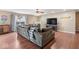 Cozy living area featuring hardwood floors, a large sectional sofa, and a welcoming fireplace at 5817 Thompson Park Blvd, Indianapolis, IN 46237