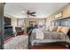 Bright main bedroom features a ceiling fan, hardwood floors, and plenty of natural light at 5817 Thompson Park Blvd, Indianapolis, IN 46237