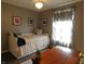 Bedroom with twin bed, neutral walls, dark wood floors, and a desk at 59 N Ridgeview Dr, Indianapolis, IN 46219