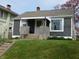 Charming gray home with a brick porch, white-framed windows, and a well-maintained lawn at 59 N Ridgeview Dr, Indianapolis, IN 46219