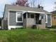 Charming single-story home with gray siding, a brick porch, and a well-manicured lawn at 59 N Ridgeview Dr, Indianapolis, IN 46219