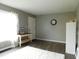 Bright living room featuring neutral gray walls and a white shag rug on modern wood flooring at 59 N Ridgeview Dr, Indianapolis, IN 46219