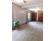 Spacious living room featuring neutral gray walls, carpeted flooring, and natural lighting at 59 N Ridgeview Dr, Indianapolis, IN 46219