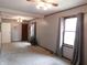 Spacious living room featuring neutral gray walls, carpeted flooring, and natural lighting at 59 N Ridgeview Dr, Indianapolis, IN 46219