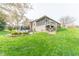Expansive backyard featuring a screened-in porch, patio seating, and lush landscaping at 6081 Boulder Ct, Columbus, IN 47201