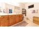 Well-lit bathroom with a double vanity, large mirror, and essential toiletries at 6081 Boulder Ct, Columbus, IN 47201