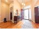 Open foyer showcasing hardwood floors, a decorative table, and a view of the front entrance at 6081 Boulder Ct, Columbus, IN 47201