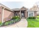 Charming brick home with a well-manicured lawn and colorful flower beds at 6081 Boulder Ct, Columbus, IN 47201