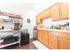 Well-organized kitchen with wooden cabinetry, stainless steel appliances, and ample counter space at 6081 Boulder Ct, Columbus, IN 47201