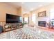 Bright living room featuring a fireplace, a cozy armchair, and a large entertainment center at 6081 Boulder Ct, Columbus, IN 47201