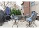 Backyard patio with seating, greenery, and a brick house with a grill in the view at 6081 Boulder Ct, Columbus, IN 47201