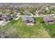 Aerial shot showcasing a brick home with a large backyard, stone patio, and mature trees in a serene community at 621 Foxboro Dr, Avon, IN 46123