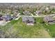 Aerial shot showcasing a brick home with a large backyard, stone patio, and mature trees in a serene community at 621 Foxboro Dr, Avon, IN 46123