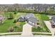 Aerial view of a charming house with a well-manicured lawn and driveway at 621 Foxboro Dr, Avon, IN 46123