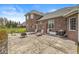 Large backyard with stone patio, outdoor cooking area, and brick facade at 621 Foxboro Dr, Avon, IN 46123