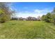 Expansive grassy backyard with trees and blue sky, located in a quiet neighborhood at 621 Foxboro Dr, Avon, IN 46123