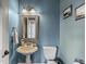 Charming bathroom with a pedestal sink, ornate mirror, and classic fixtures at 621 Foxboro Dr, Avon, IN 46123