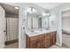 Bright bathroom featuring a double sink vanity, a large mirror, neutral walls, and a shower/bathtub combo creating a spa-like feel at 621 Foxboro Dr, Avon, IN 46123