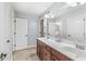 Bright bathroom with a double sink vanity and a large mirror at 621 Foxboro Dr, Avon, IN 46123