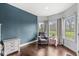 Cozy bedroom with hardwood floors, an accent wall, a comfortable recliner, and plenty of natural light at 621 Foxboro Dr, Avon, IN 46123