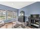 Bedroom with wood floors and lots of natural light with a large window with neighborhood views at 621 Foxboro Dr, Avon, IN 46123