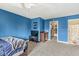 Bright blue bedroom with view of an en-suite bath and walk-in closet at 621 Foxboro Dr, Avon, IN 46123