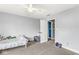 Neutral toned bedroom with a ceiling fan and doorway to an en-suite bathroom at 621 Foxboro Dr, Avon, IN 46123