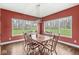 Dining room with a wooden table and six chairs, lit by a modern pendant light at 621 Foxboro Dr, Avon, IN 46123