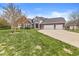 Charming brick home featuring an attached three car garage and a well-manicured front lawn at 621 Foxboro Dr, Avon, IN 46123