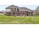 Expansive brick home with well manicured lawn, and lush greenery surrounding the property at 621 Foxboro Dr, Avon, IN 46123